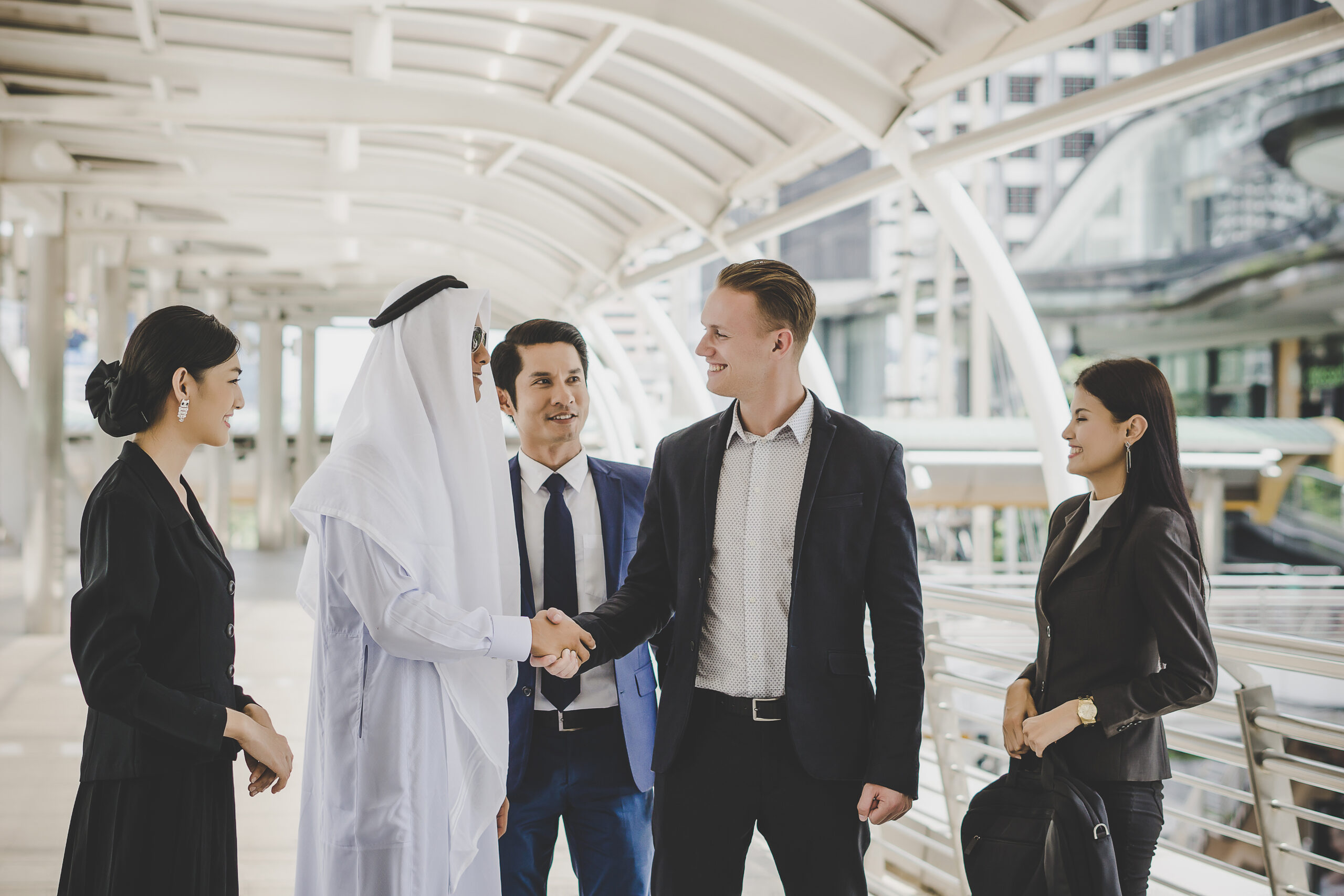 portrait business partners greeting one another by handshaking way office scaled